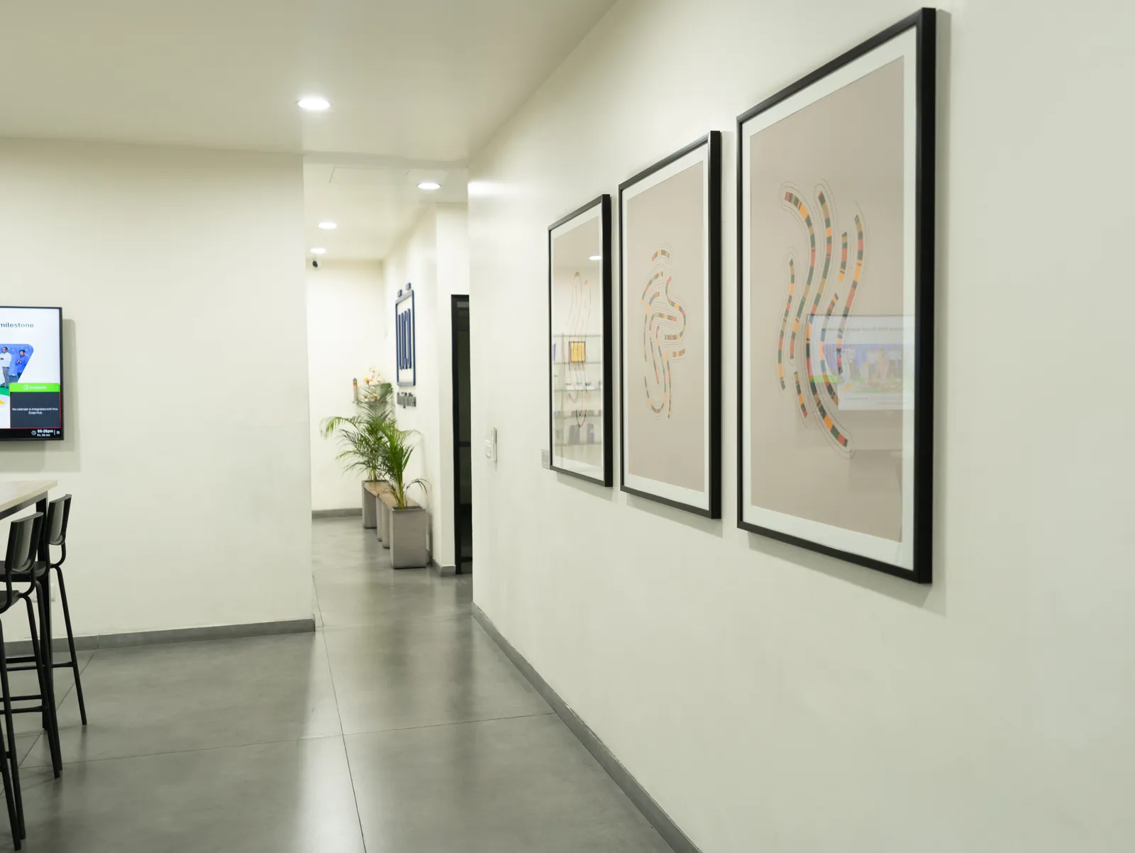 Office corridor lined with framed artwork — LICO